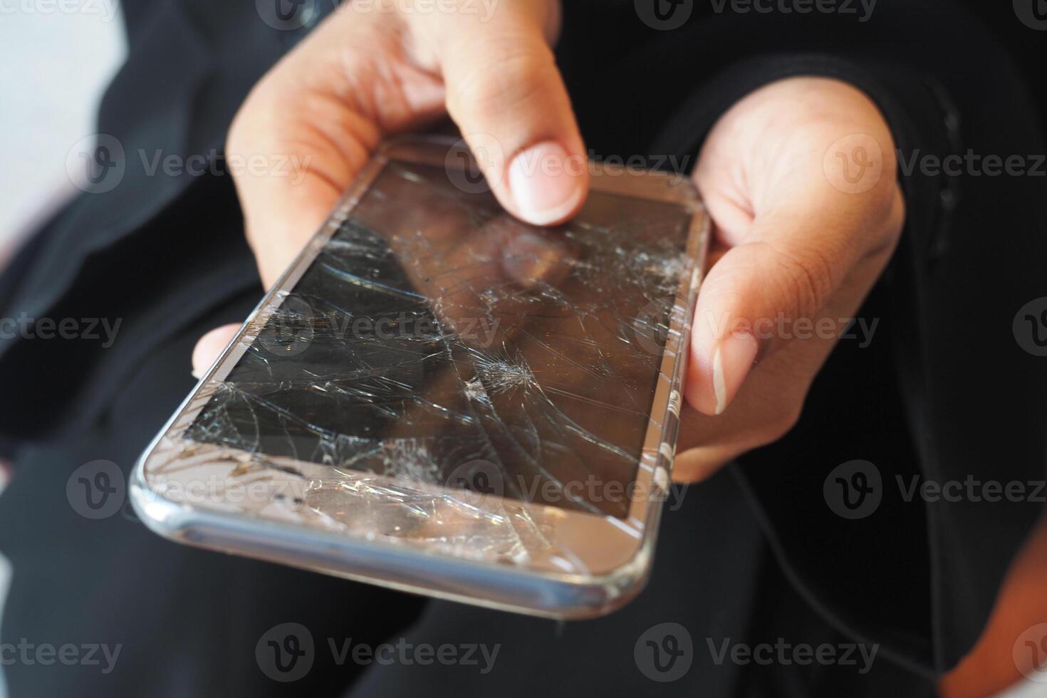 Close up of woman hand holding broken smart phone. photo