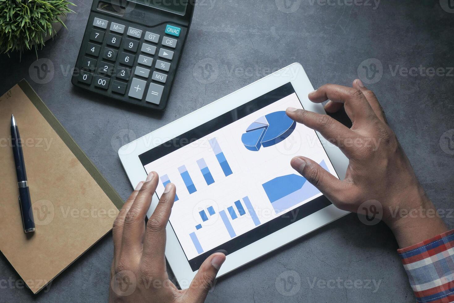 Hands Utilizing a Tablet Device to Analyze Data and Financial Charts in a Structured Manner photo