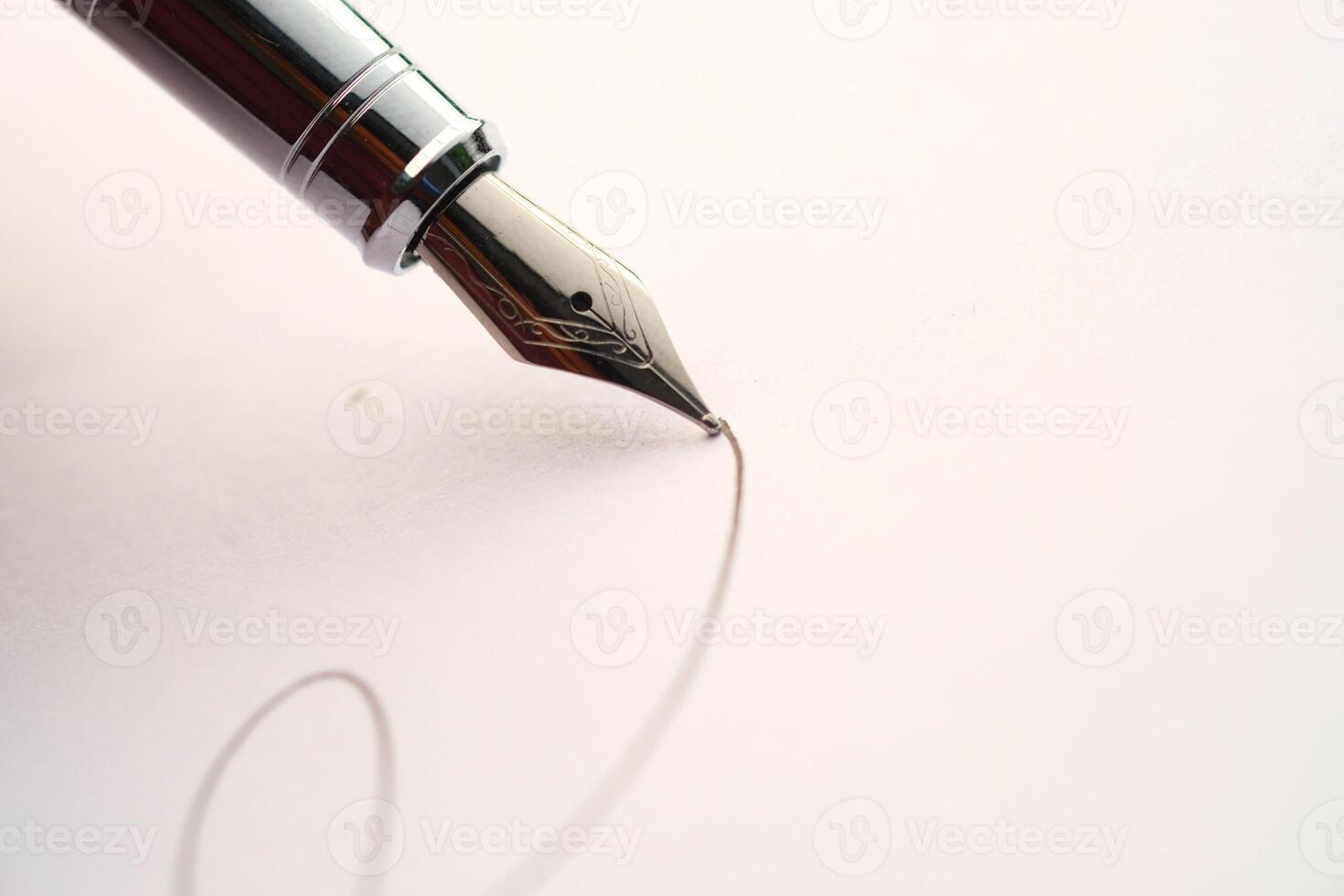 A CloseUp of an Elegant Fountain Pen Poised to Write Beautifully on Crisp Clean Paper photo