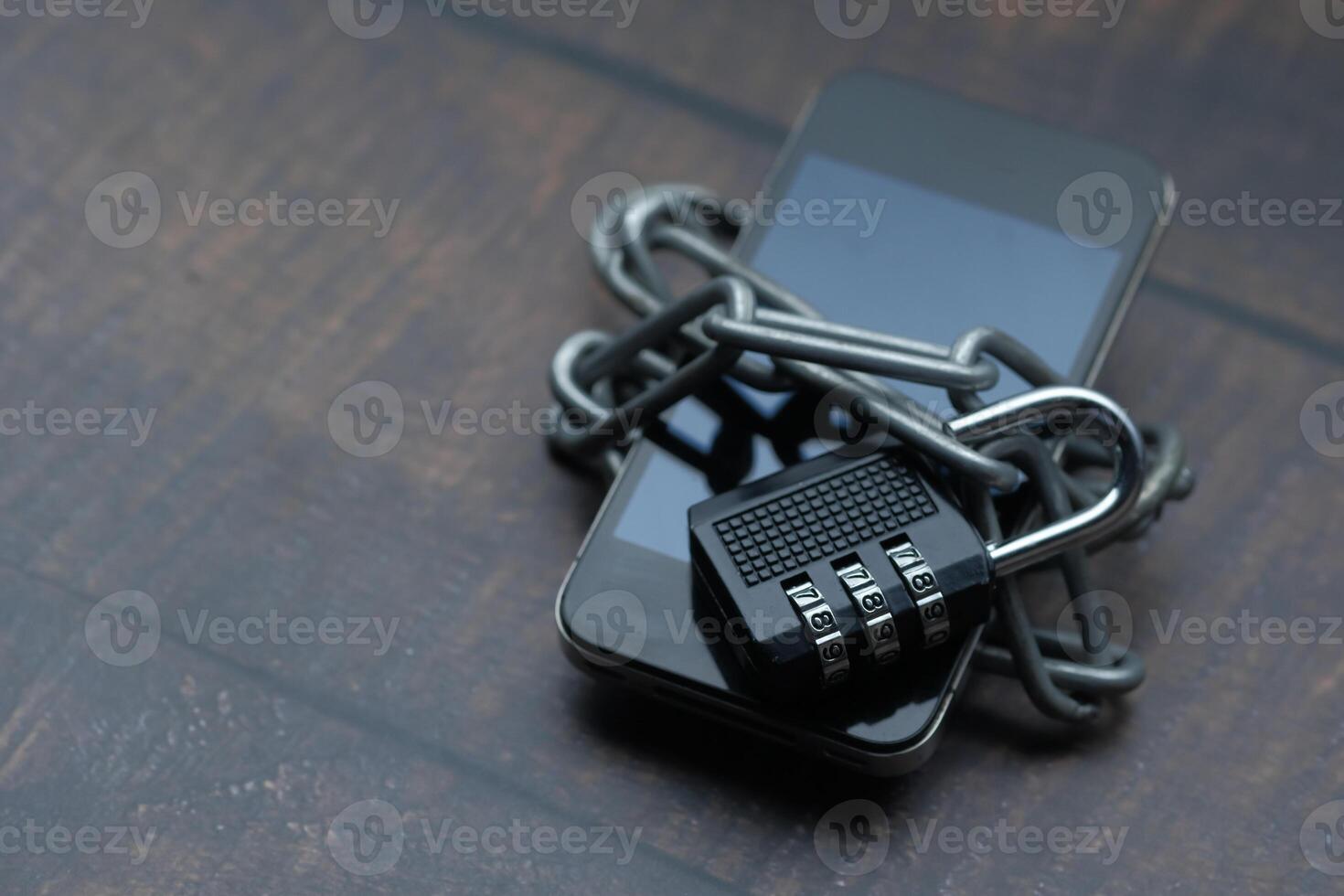 Ensuring Security and Privacy with a Mobile Phone Visualizing a Device Enclosed by Lock and Chains photo