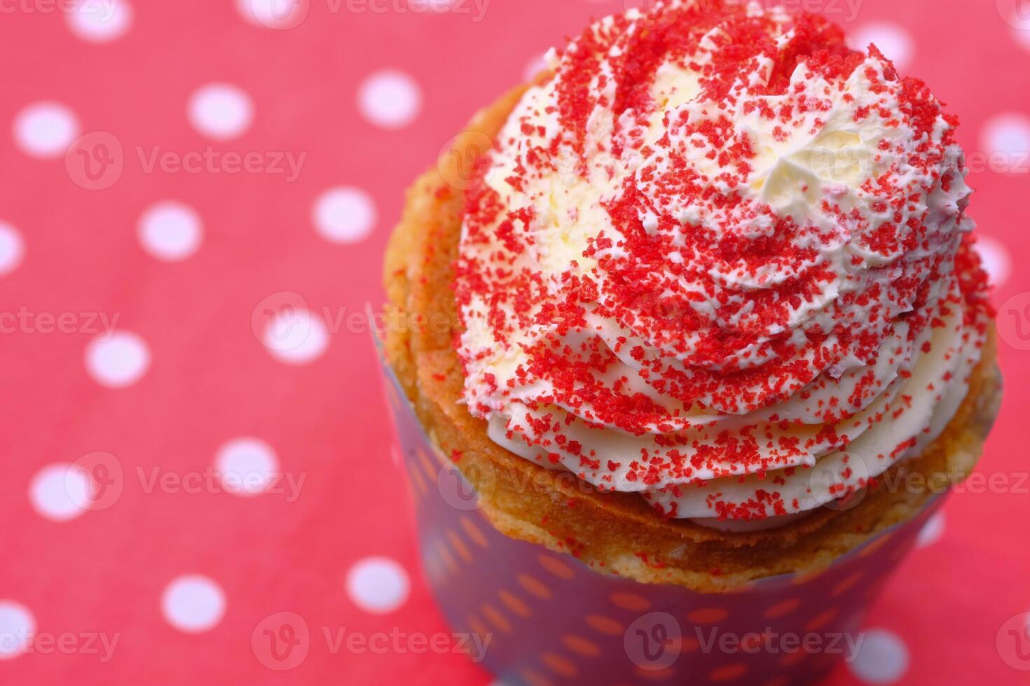 Enjoy a delightful cupcake topped with whipped cream and bright red sprinkles for any occasion photo
