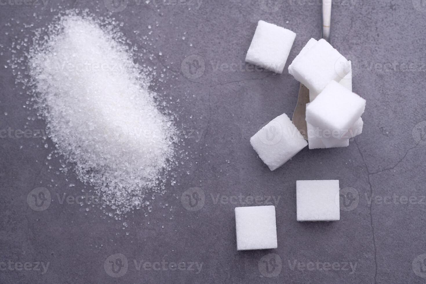 Granulated Sugar and Cube Sugar Placed on a Dark Surface for a Lavish Presentation photo