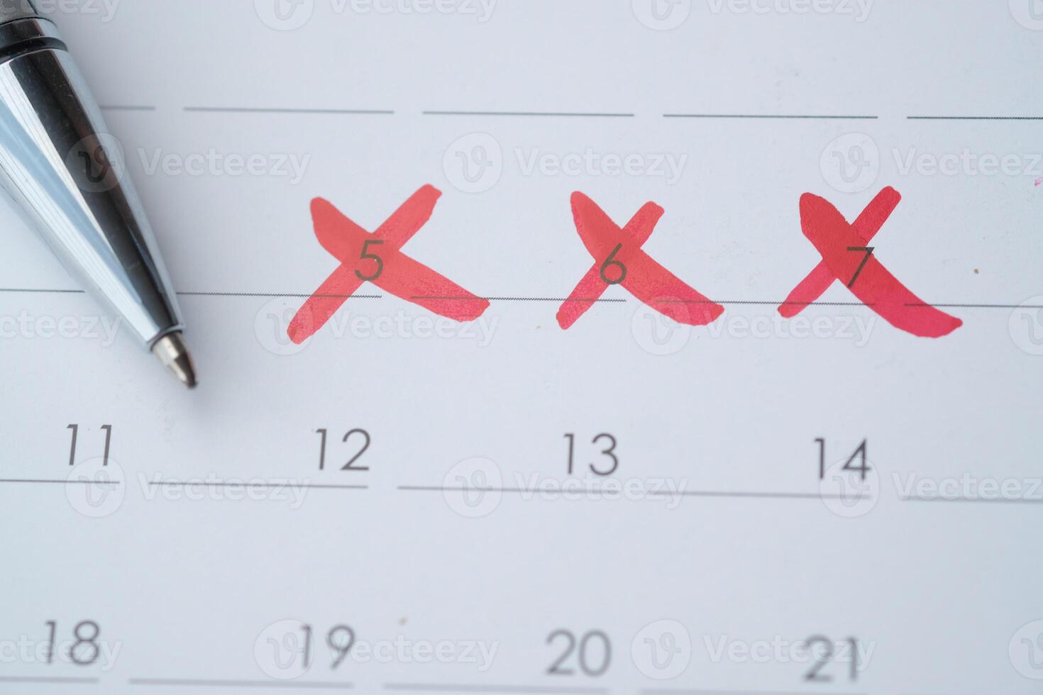 A calendar featuring numerous dates crossed out with a pen can help in planning effectively photo