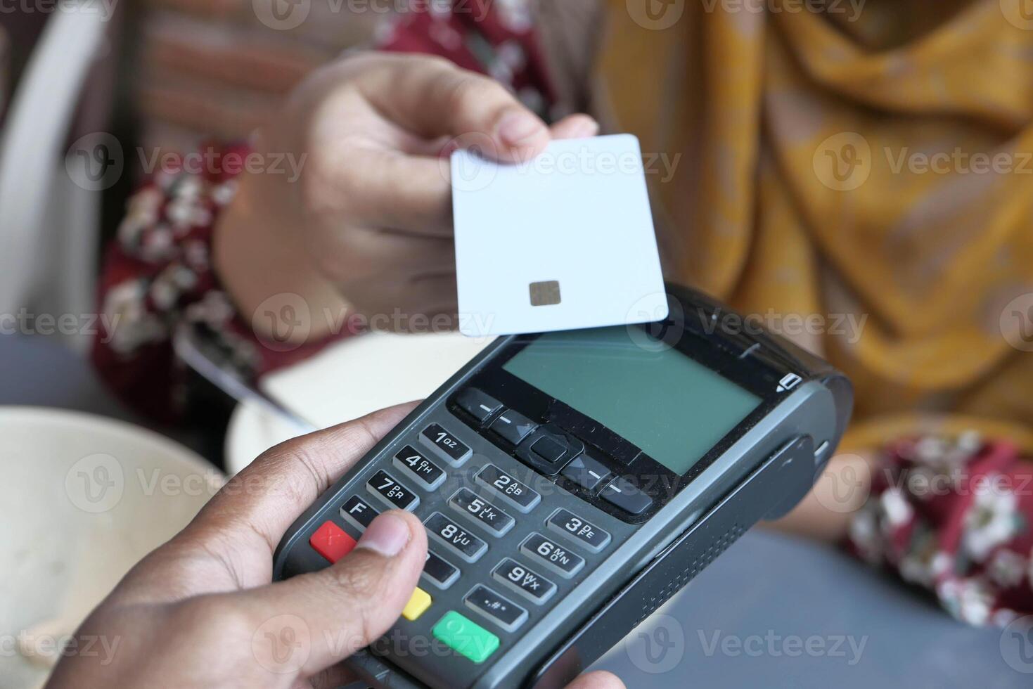Experience the convenience of contactless payment using a card device at your local cafe photo