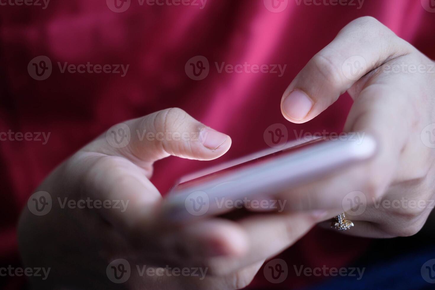 A closeup shows hands with a smartphone in soft lighting, highlighting usertech connection photo