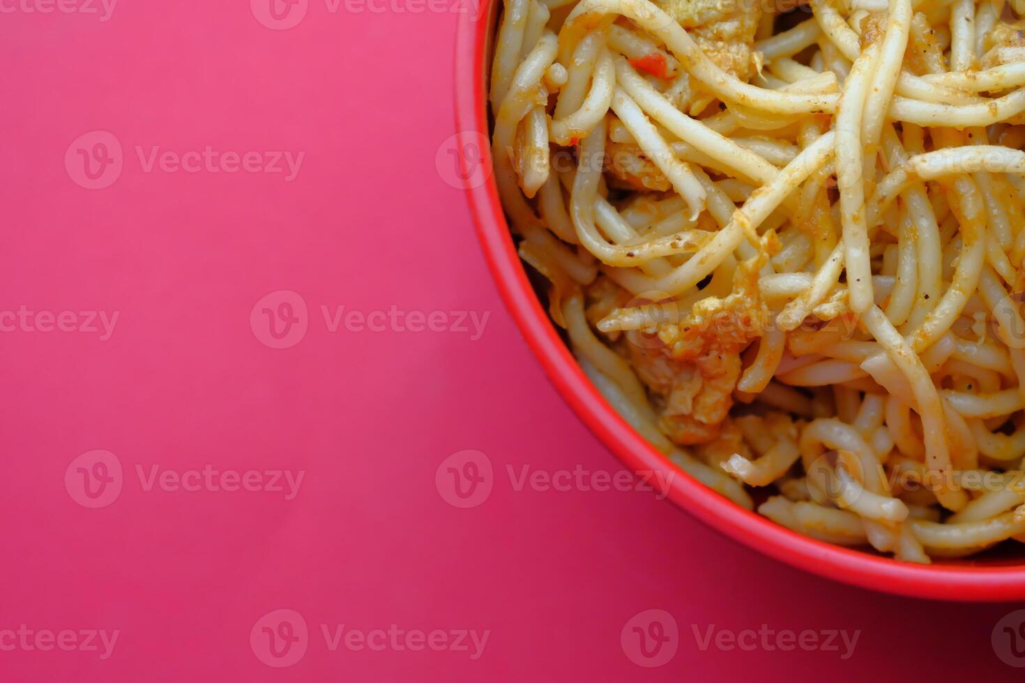 A bowl filled with delicious noodles presented beautifully on a vibrant and bright background photo
