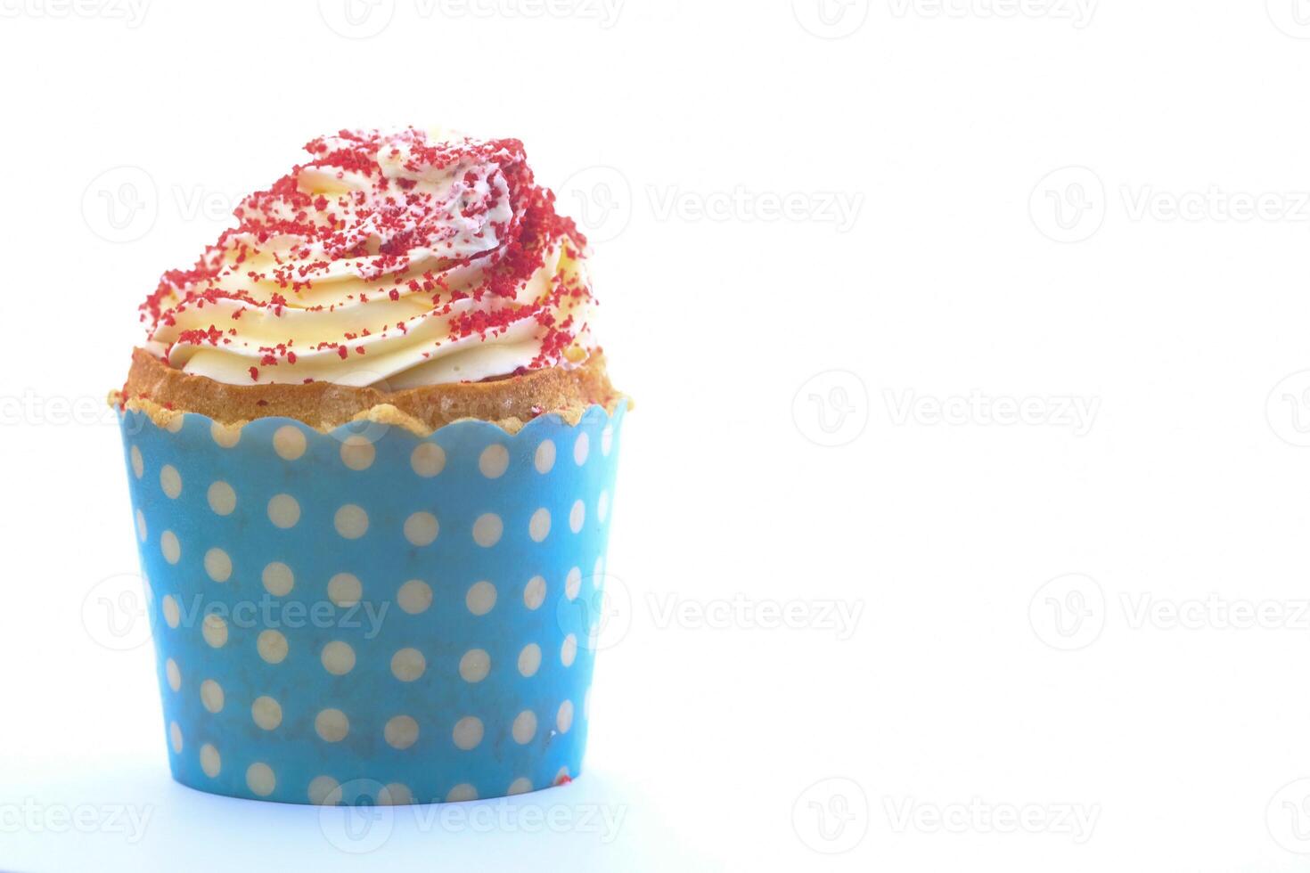 A Delicious Cupcake topped with Creamy Frosting and colorful Sprinkles awaits you photo