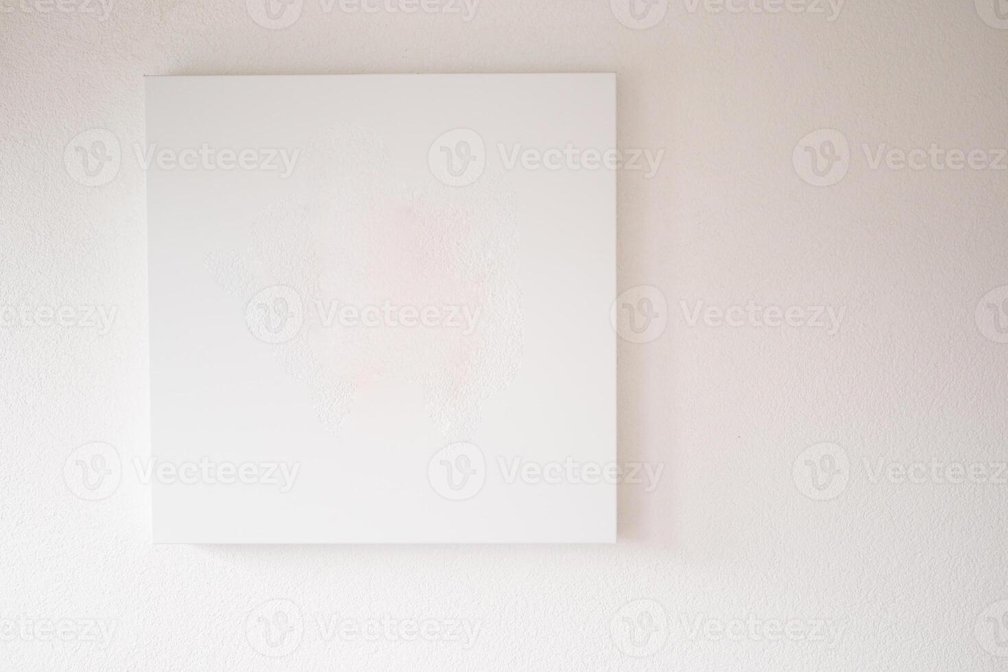 A Minimalist Empty Canvas Displayed on a White Wall, Perfect for Artistic Backgrounds photo