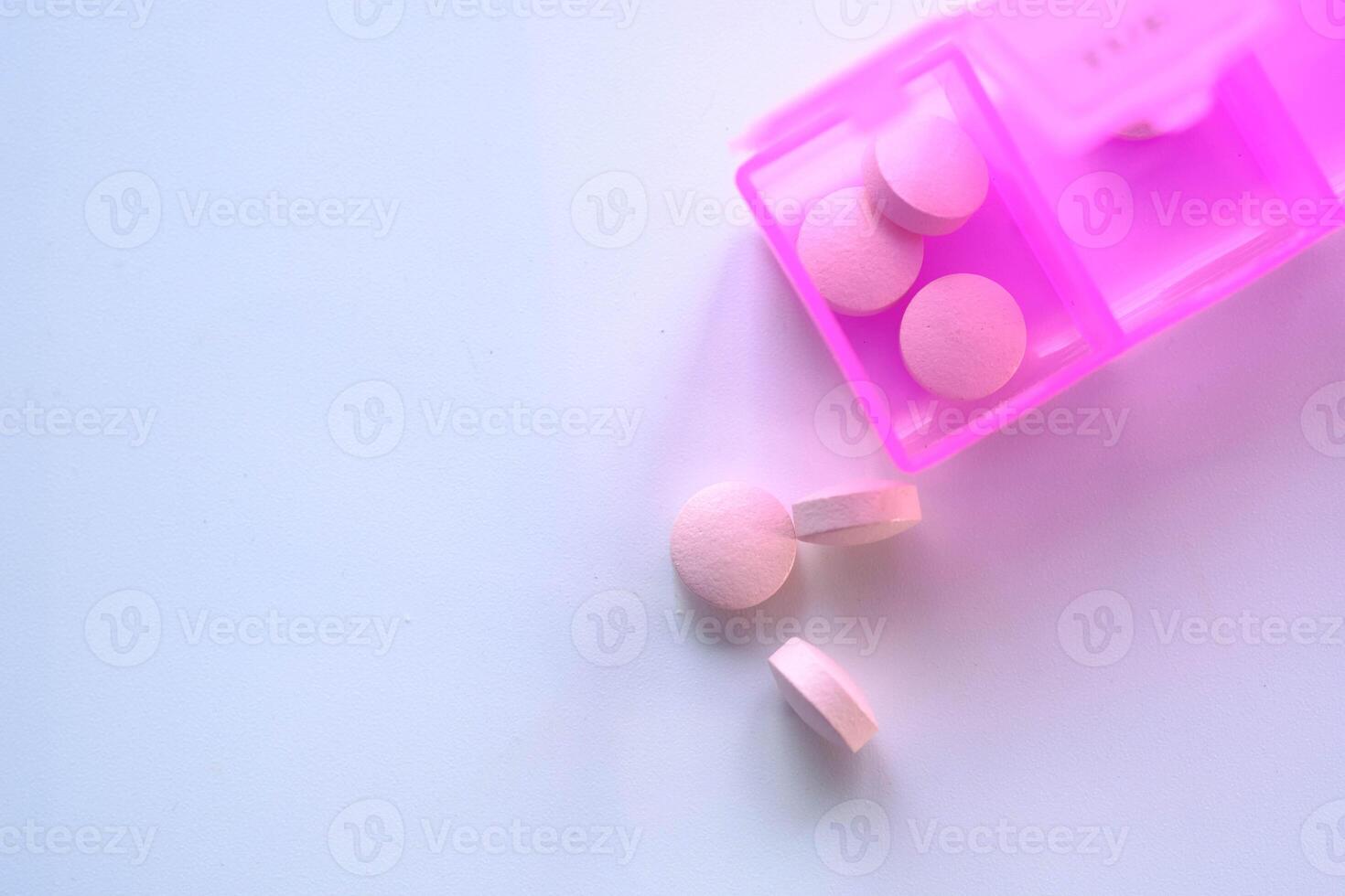 A colorful pill organizer showcasing various tablets against a soft, subtle background photo