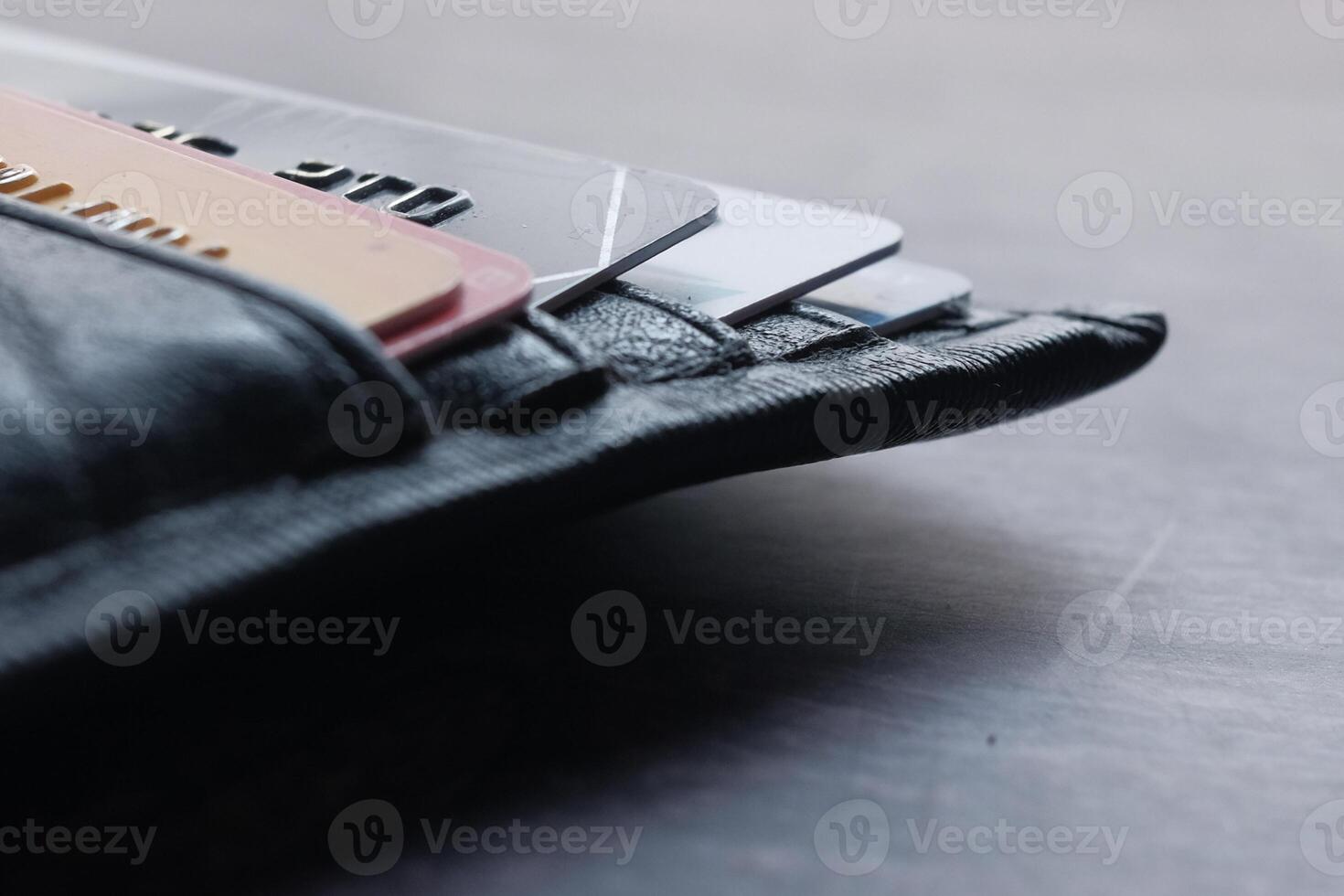 A detailed closeup image showcases a wallet abundantly filled with numerous credit cards inside it photo