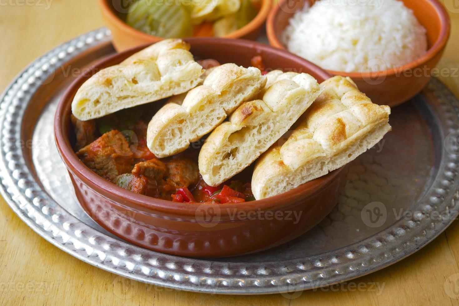 Enjoy a Traditional Dish with Bread, Rice, and flavorful Pickles that tantalize taste buds photo