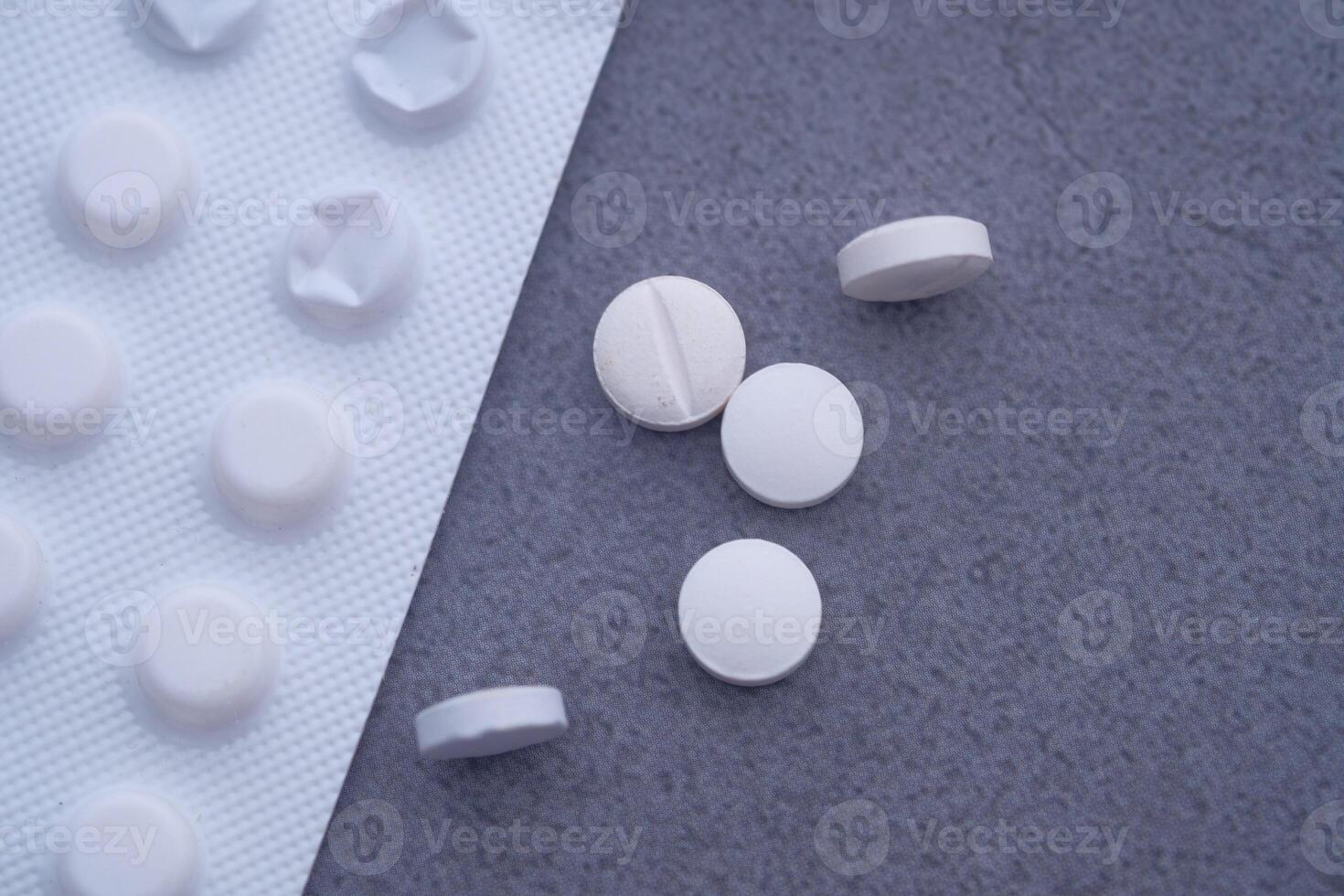 A Diverse Selection of White Tablets Arranged Neatly on a Grey Surface Background photo