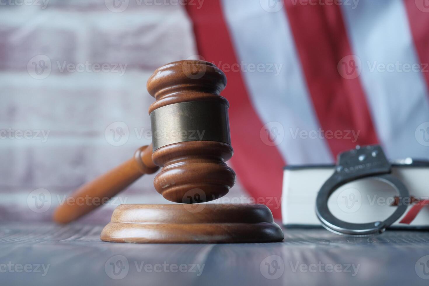 Justice and Law A Gavel, Handcuffs, and Legal Books Arranged Neatly on an Oak Desk photo