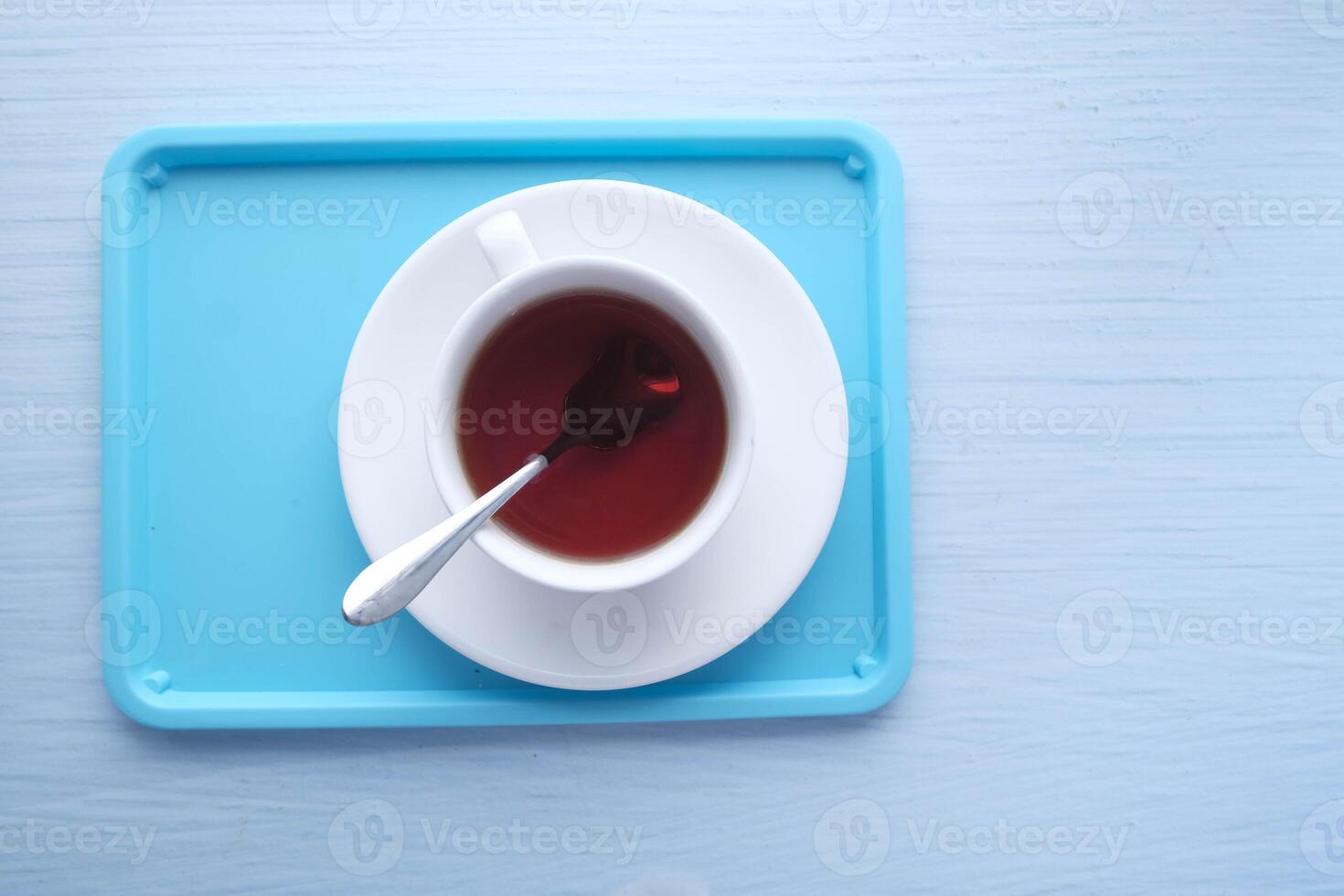 A delightful Cup of Tea gracefully placed on a lovely Blue Tray, ready to be enjoyed photo