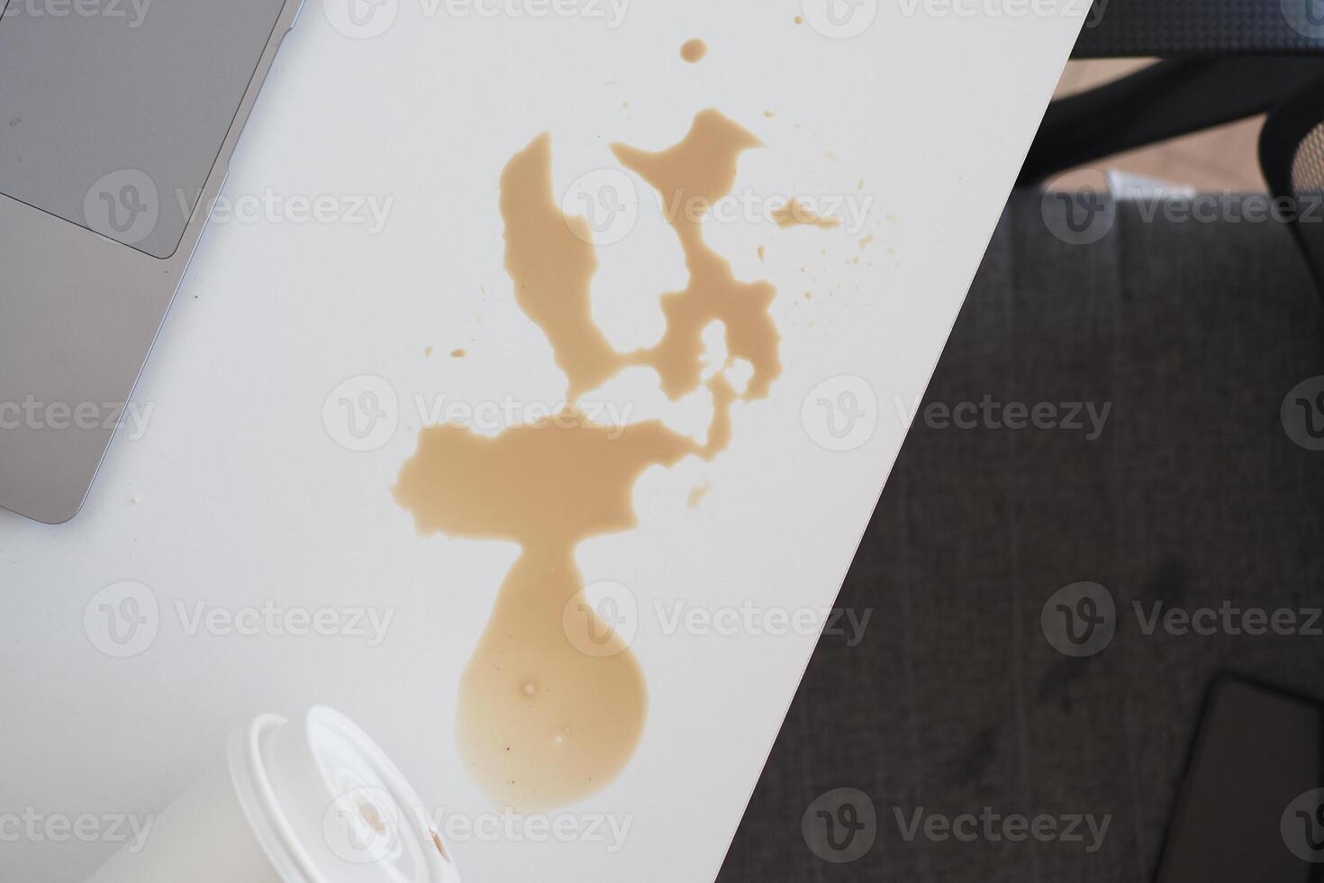 A white table with a laptop and a cup of coffee photo
