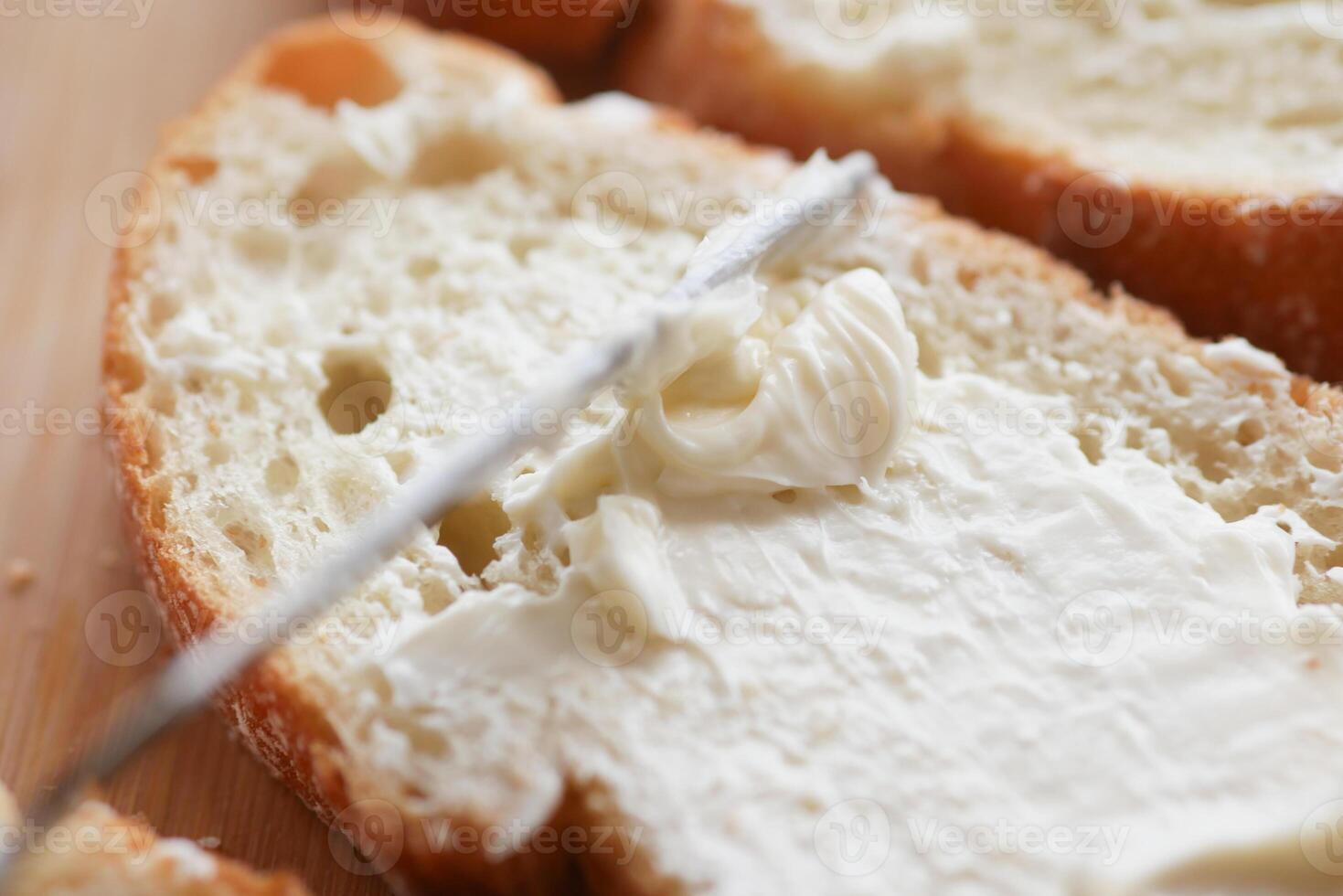 fresh butter spreading on a bread photo