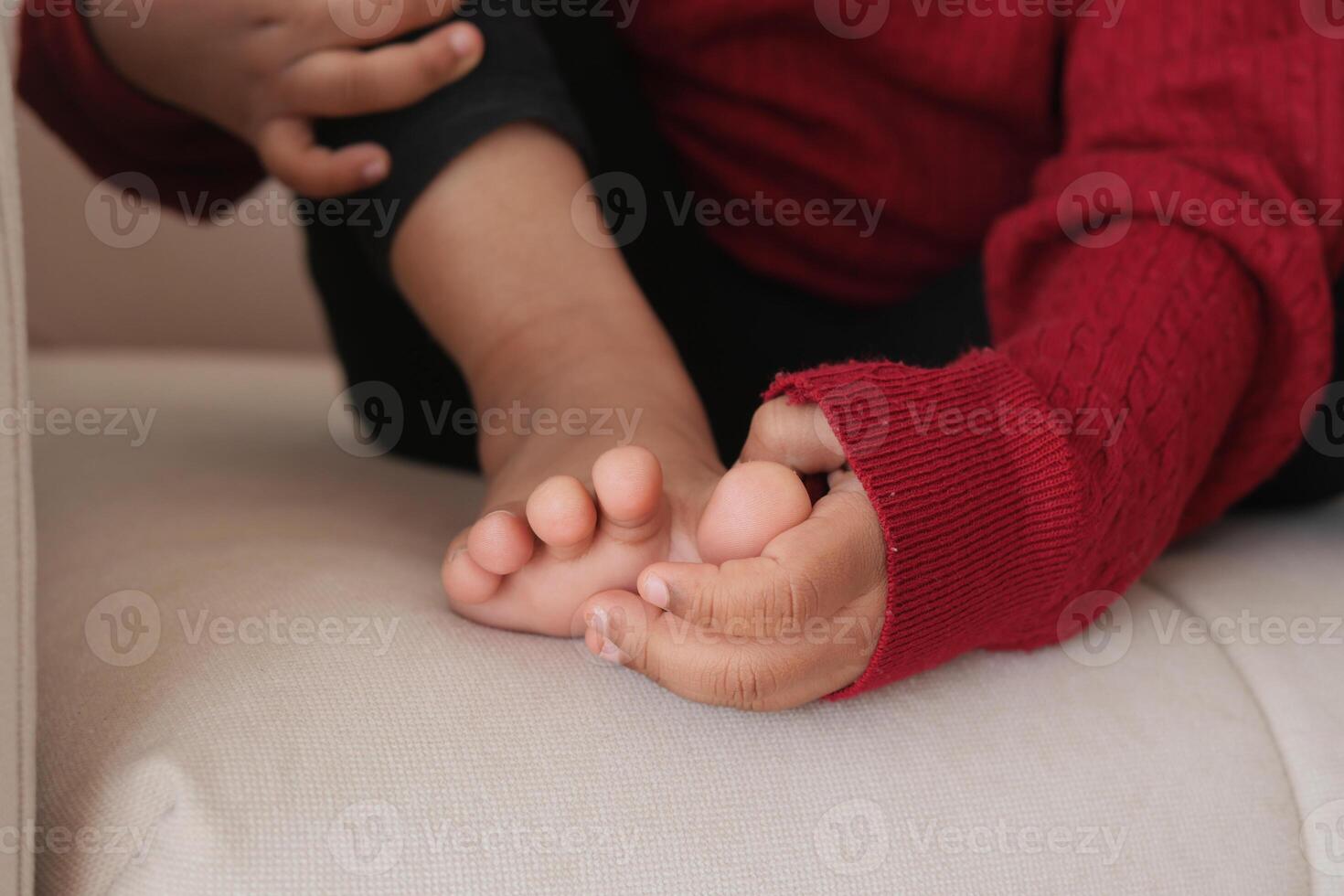 6 year old child suffering pain on feet photo