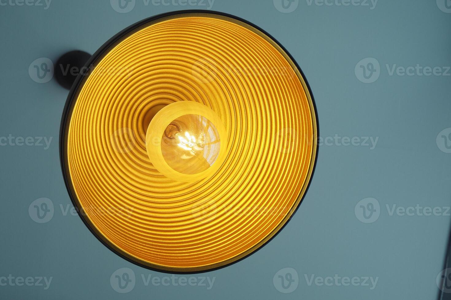 This is a modern yellow ceiling light fixture that features an elegant spiral design photo