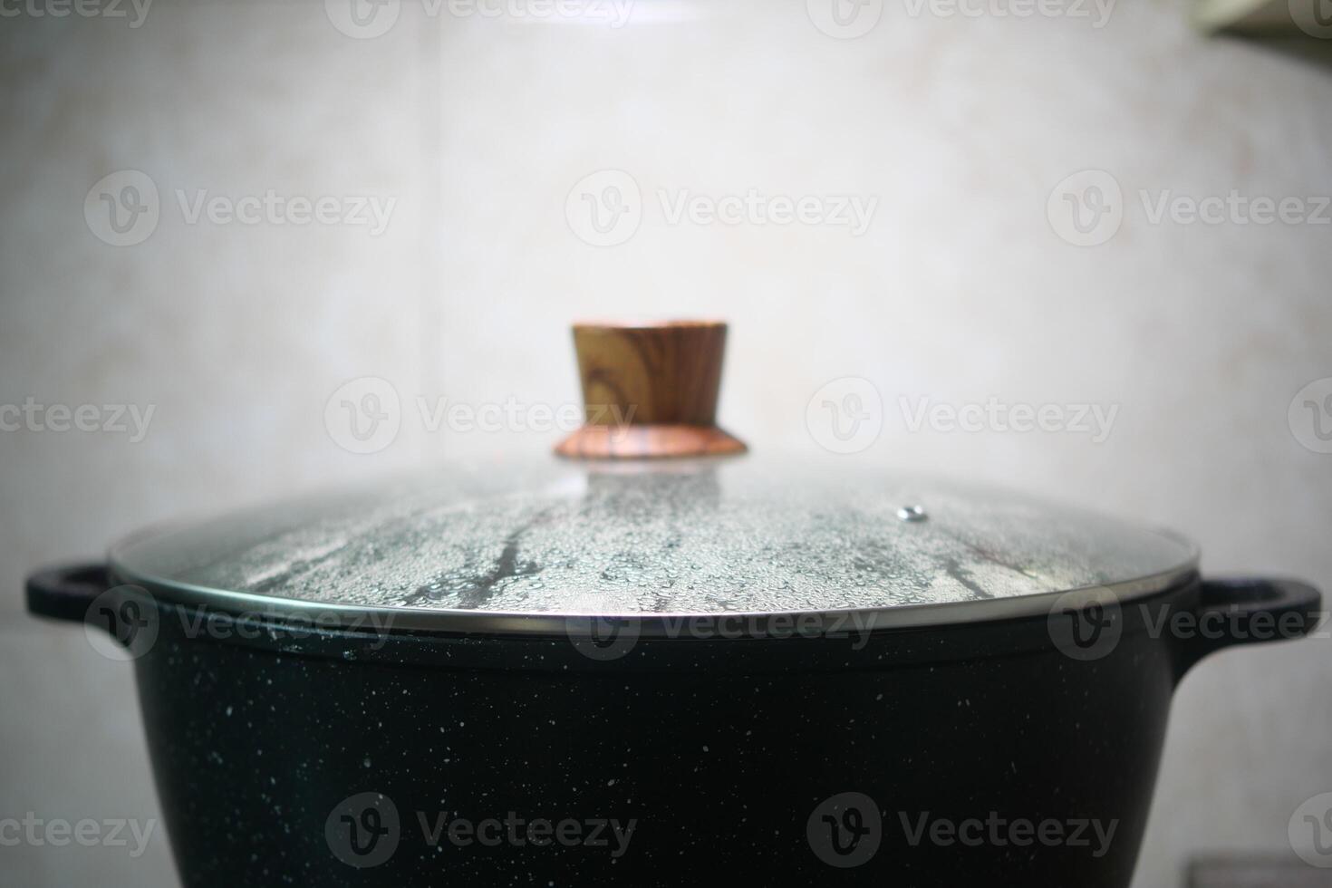 A detailed closeup image of a steaming pot that is covered with a traditional wooden lid photo