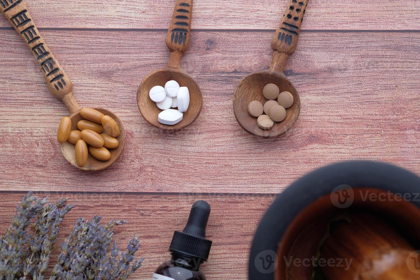 Natural Supplements and Herbal Remedies Displayed on a Wooden Surface for Wellness Purposes photo