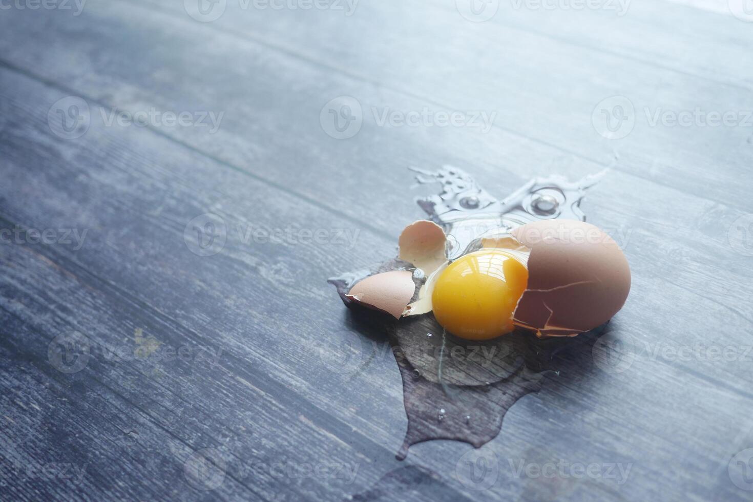 Fresh broken egg in kitchen floor photo