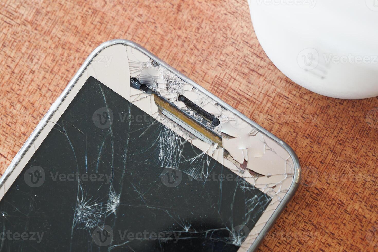 Top view of broken smart phone on color background photo