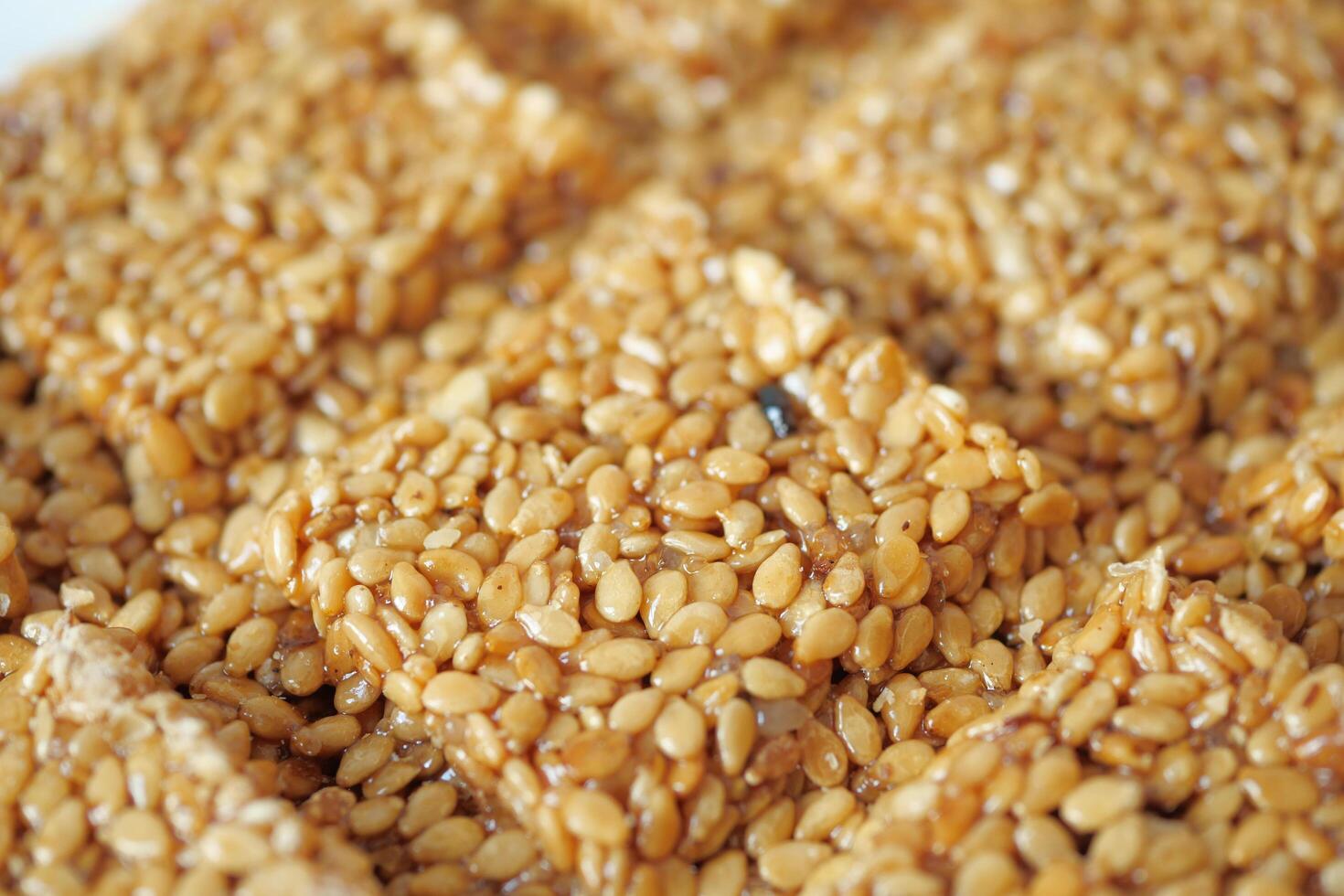 This is a delightful closeup photograph showing a homemade sesame seed brittle treat photo