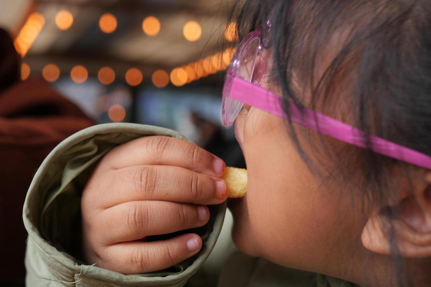 child eating french fries close up photo