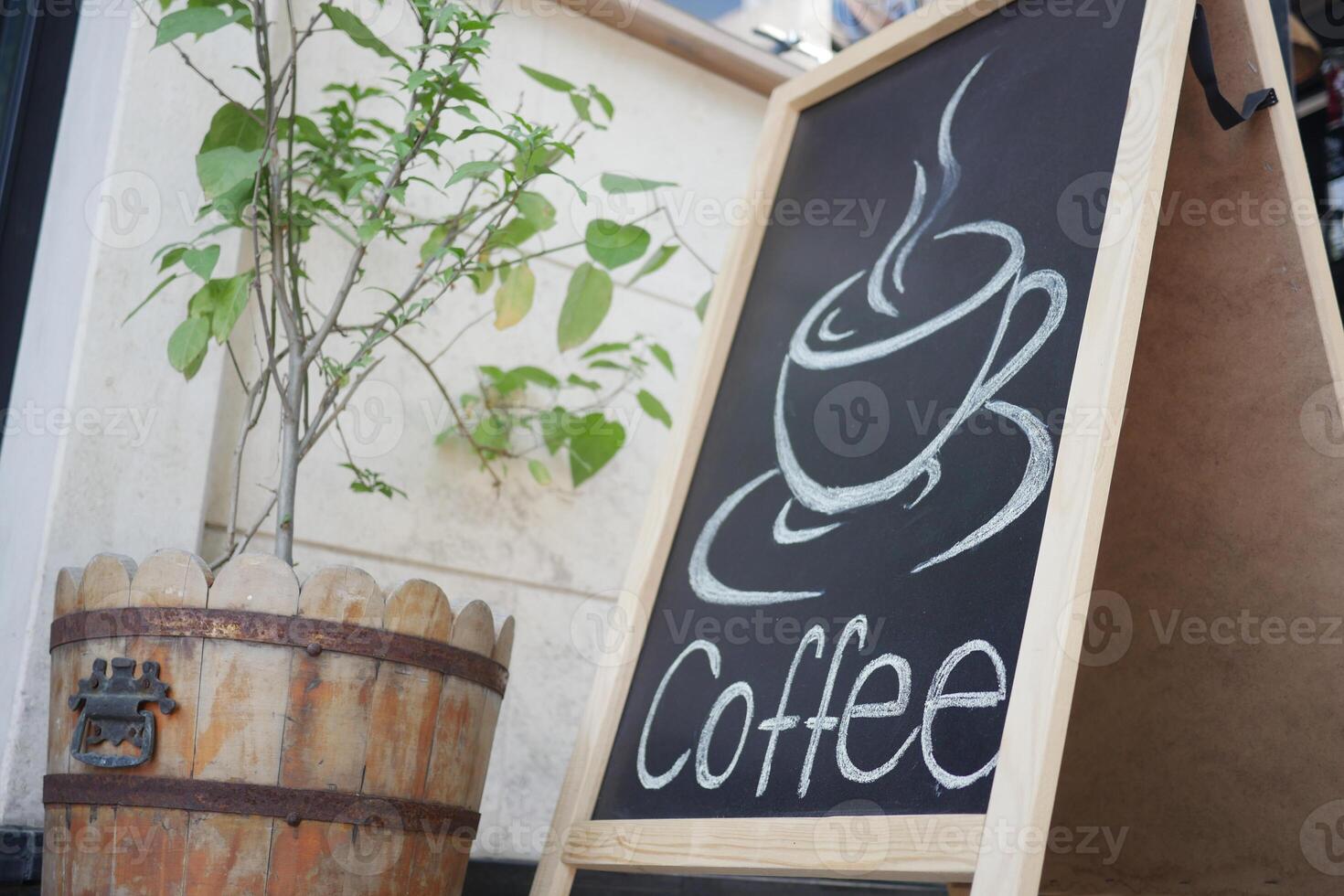 Charming Quaint Coffee Shop Sign Featuring a Beautiful Wooden Planter Displaying Plants photo