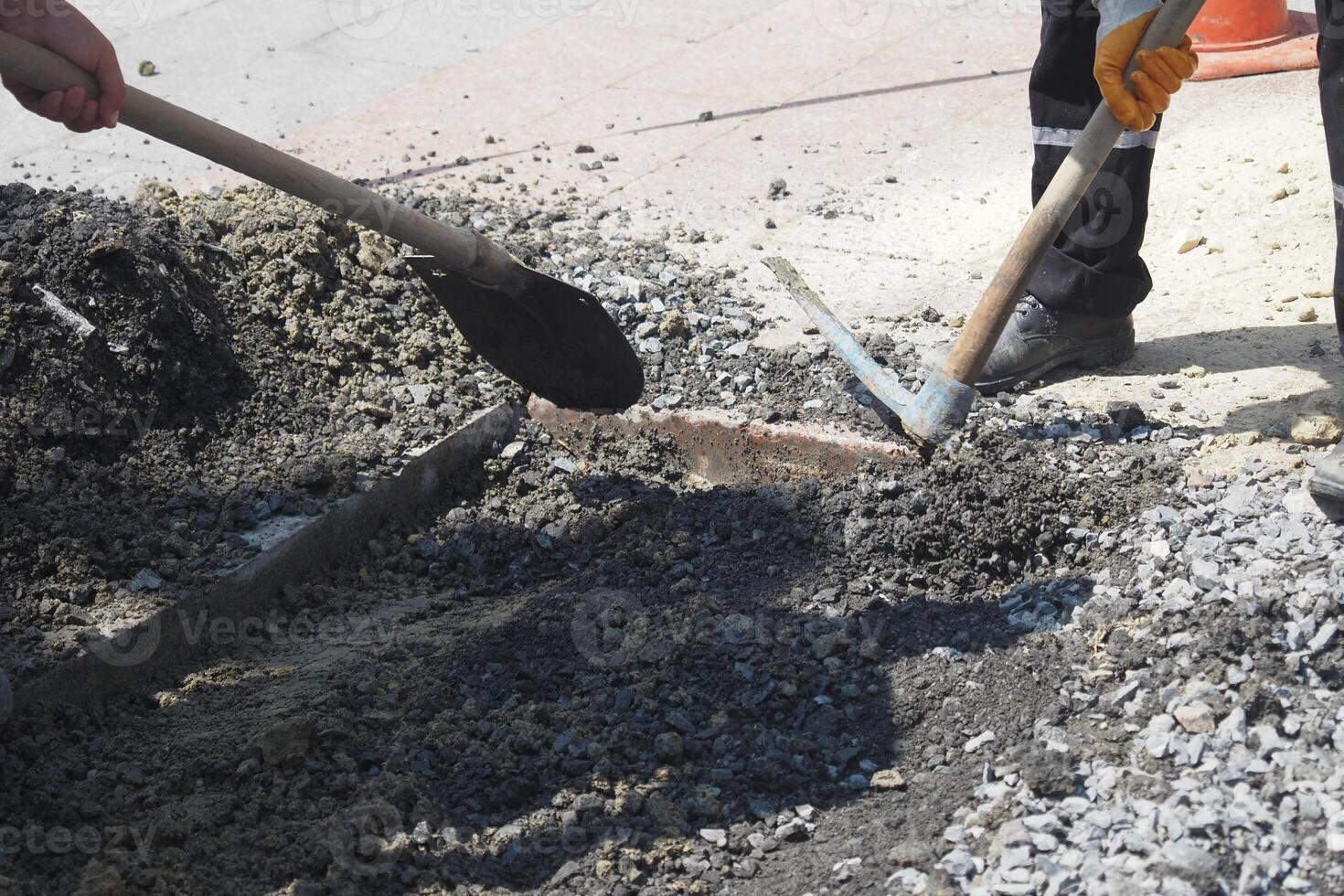Dedicated Construction Workers Engaged in Paving and Efficiently Mixing Concrete on Site photo