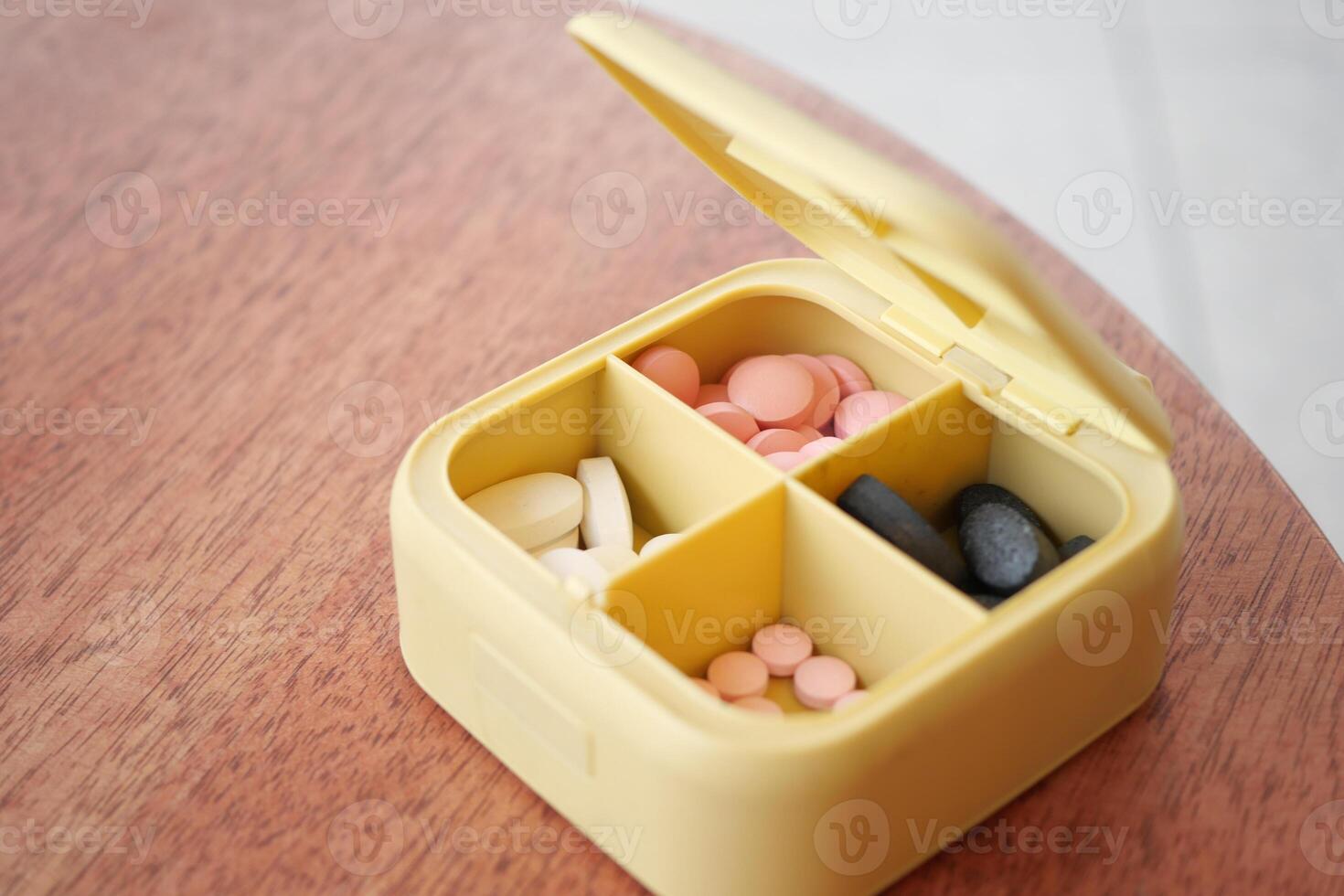 close up of medical pills in a pill box on table photo