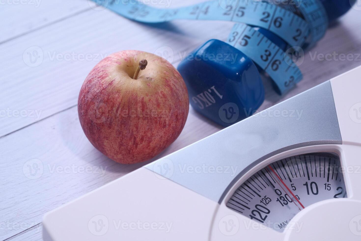 Fundamental Elements of a Healthy Lifestyle Fresh Apple, Weights for Workouts, and Accurate Scale photo