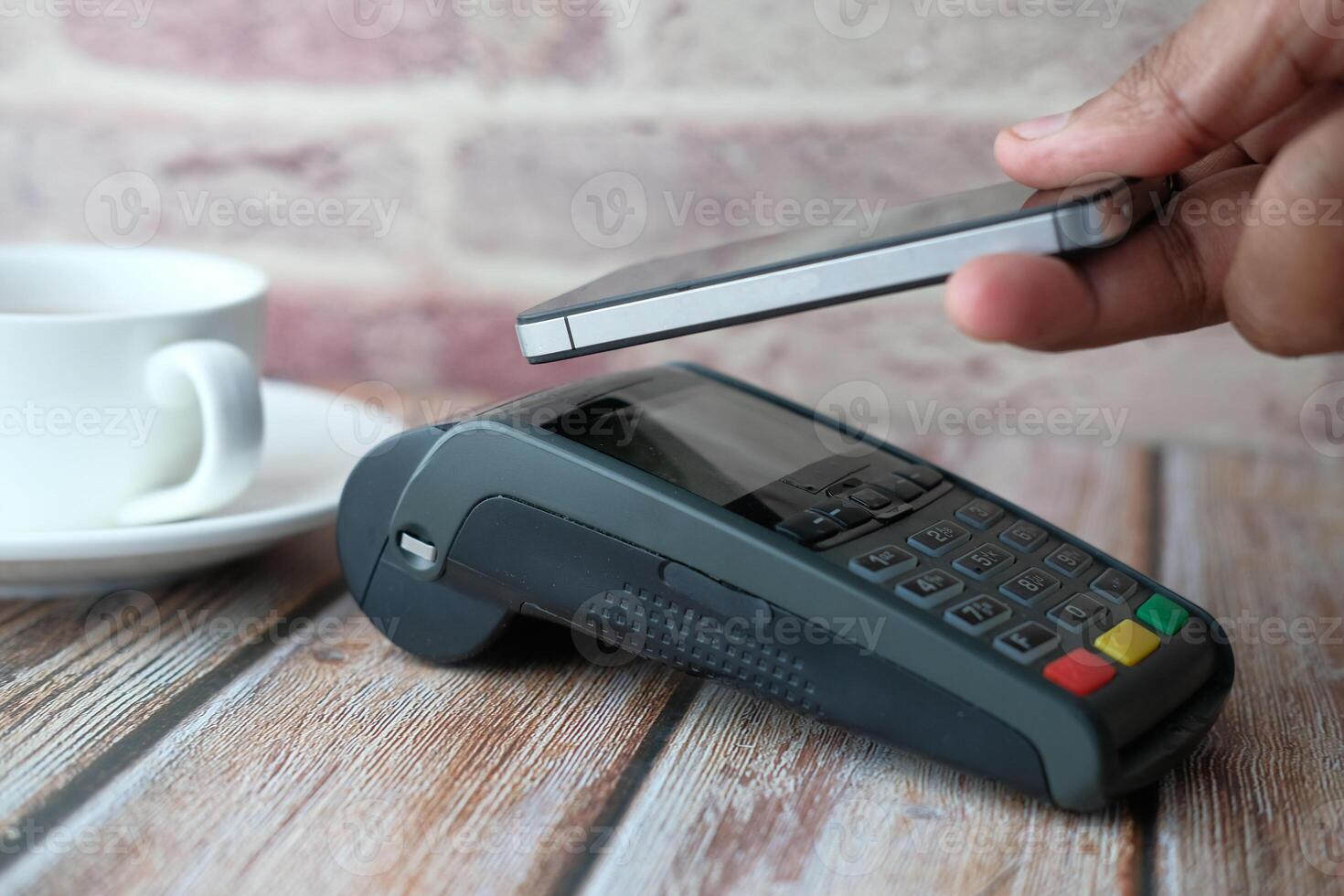 Executing a Mobile Payment Transaction by utilizing a Card Reader while purchasing Coffee photo