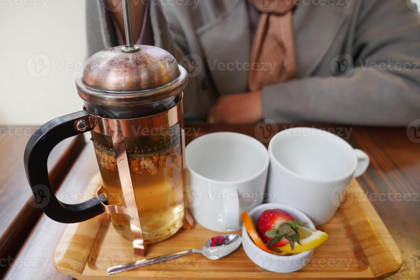 Enjoy a cozy tea experience featuring a delightful French press and an array of fresh, tasty fruits photo