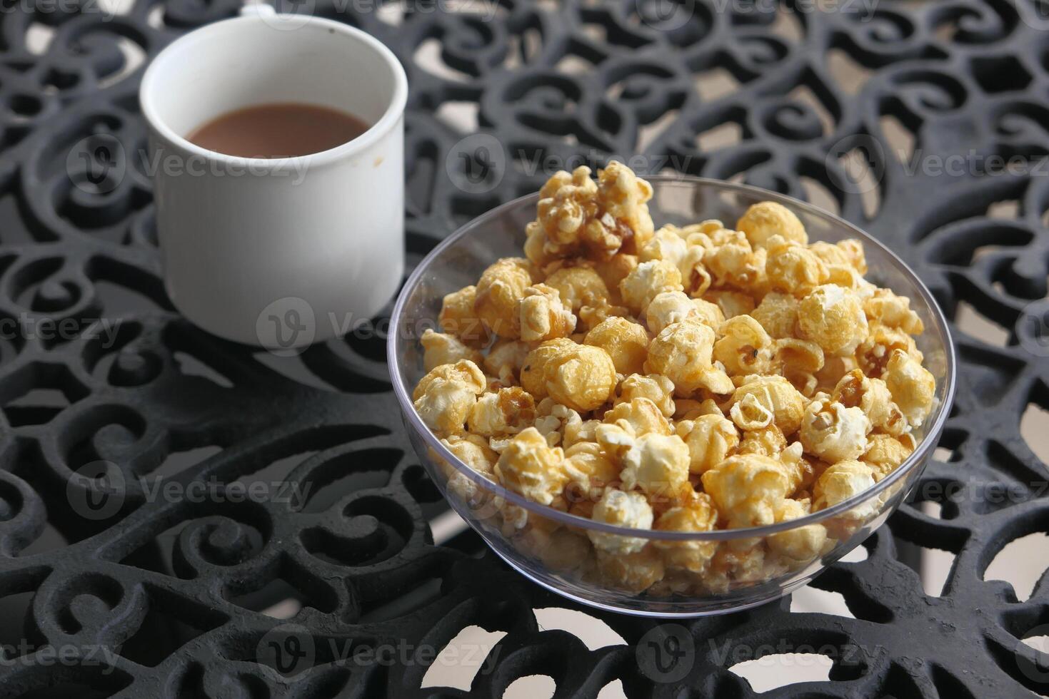 Savoring Delicious Popcorn and a Warm Cup of Coffee on a Beautifully Decorative Table photo