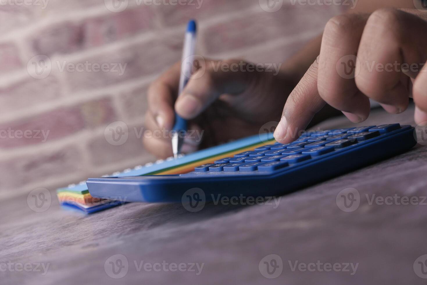 Calculating with a Calculator and Notepad in a Cozy Study Environment for Efficiency photo