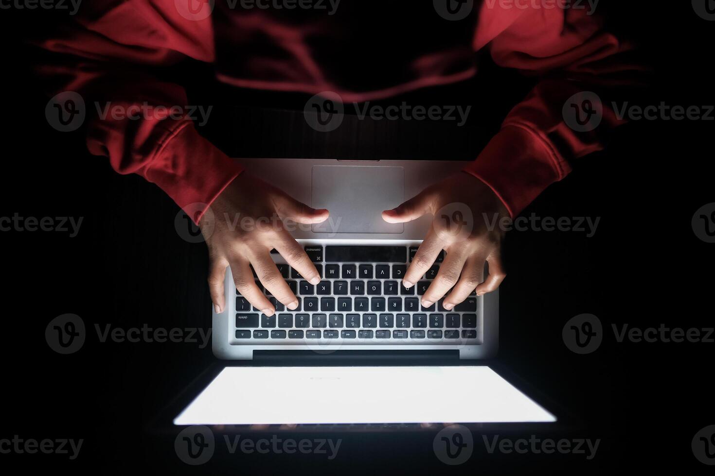 hacker hand stealing data from laptop top down photo