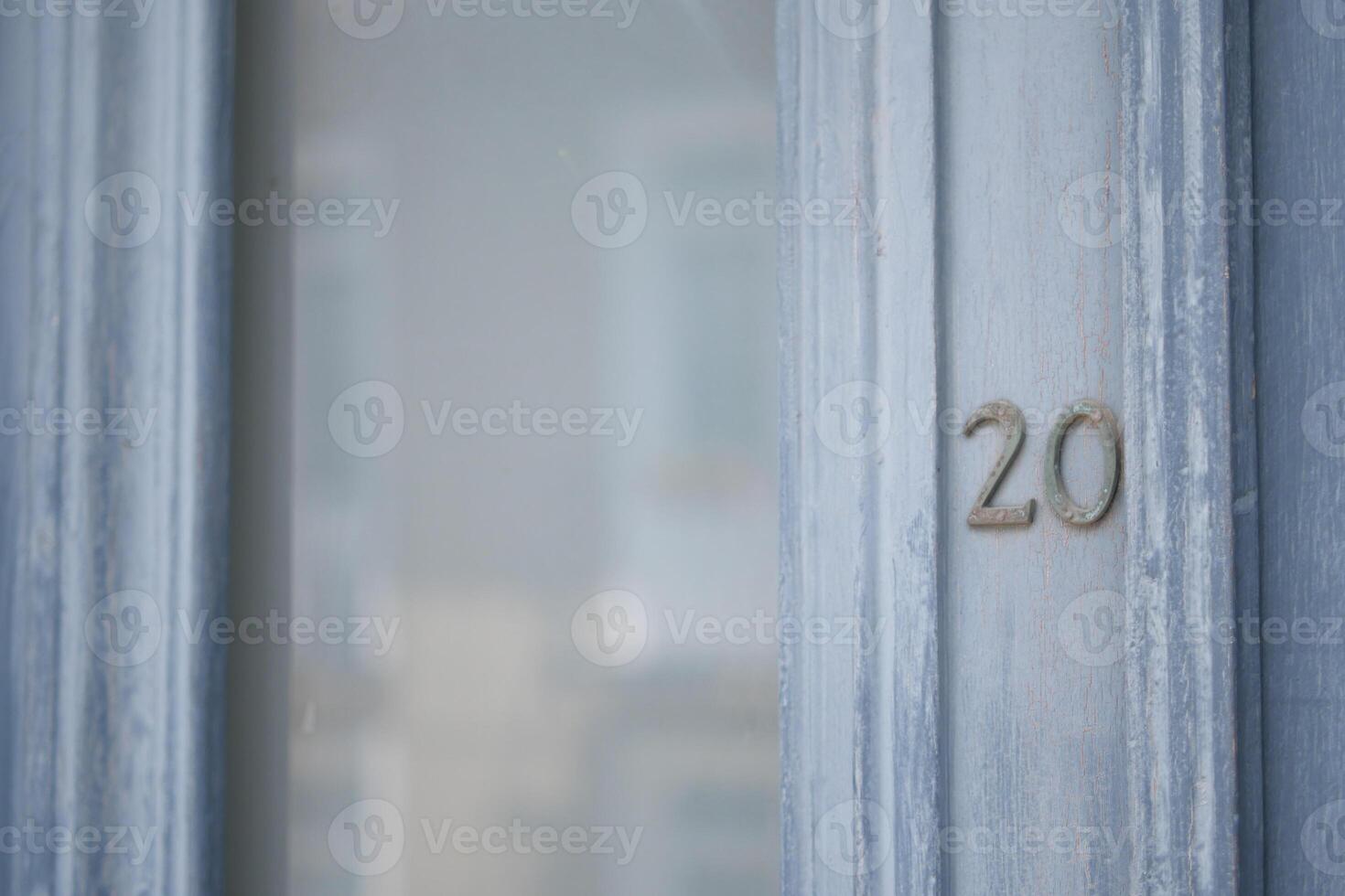 An Elegant Blue Door featuring an ornate Number 20 detail that adds charm and character photo