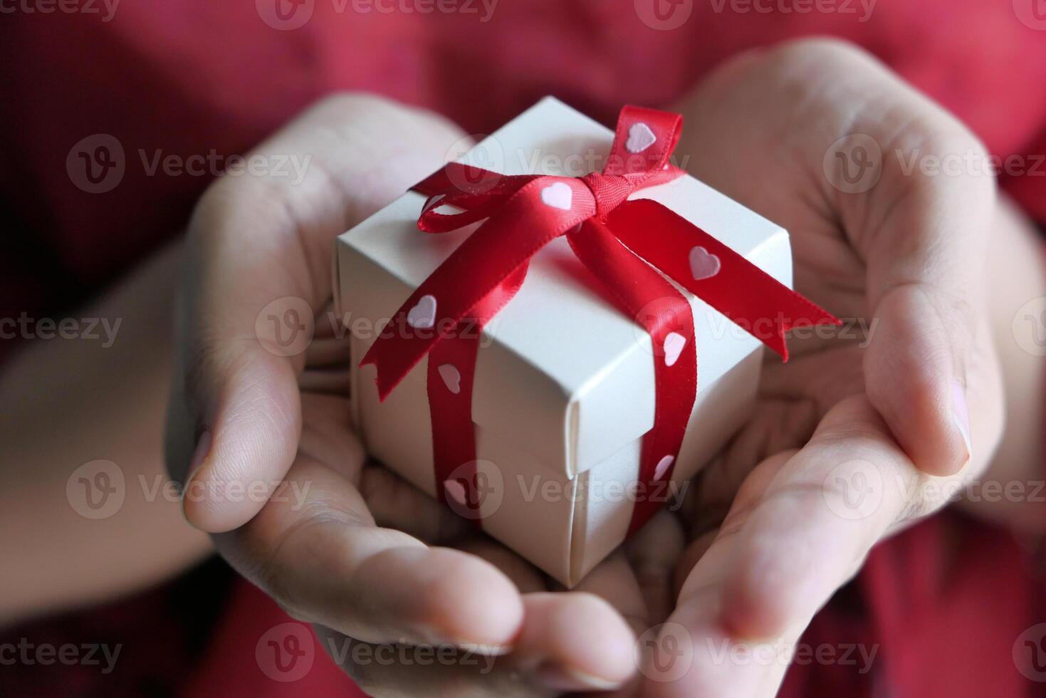 A Thoughtful Gift Wrapped Beautifully in a HeartEmbellished Ribbon for Special Occasions photo