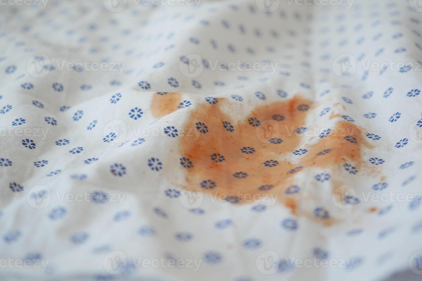 Stained Fabric CloseUp Detailed View of Patterned Material Featuring an Orange Mark photo