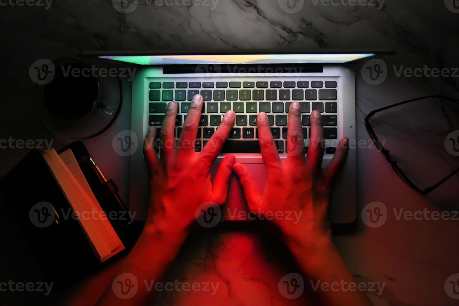 hacker hand stealing data from laptop top down photo
