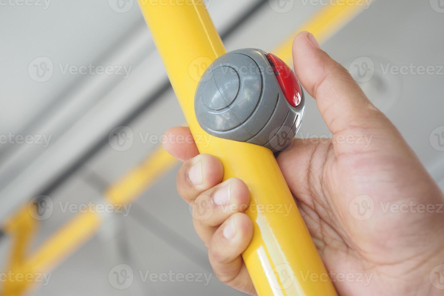 Closeup of pressing Bus bell switch for stop inside the public bus photo