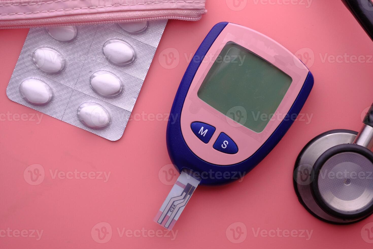 Diabetes monitoring tools include glucometers, medications, and stethoscopes for care photo