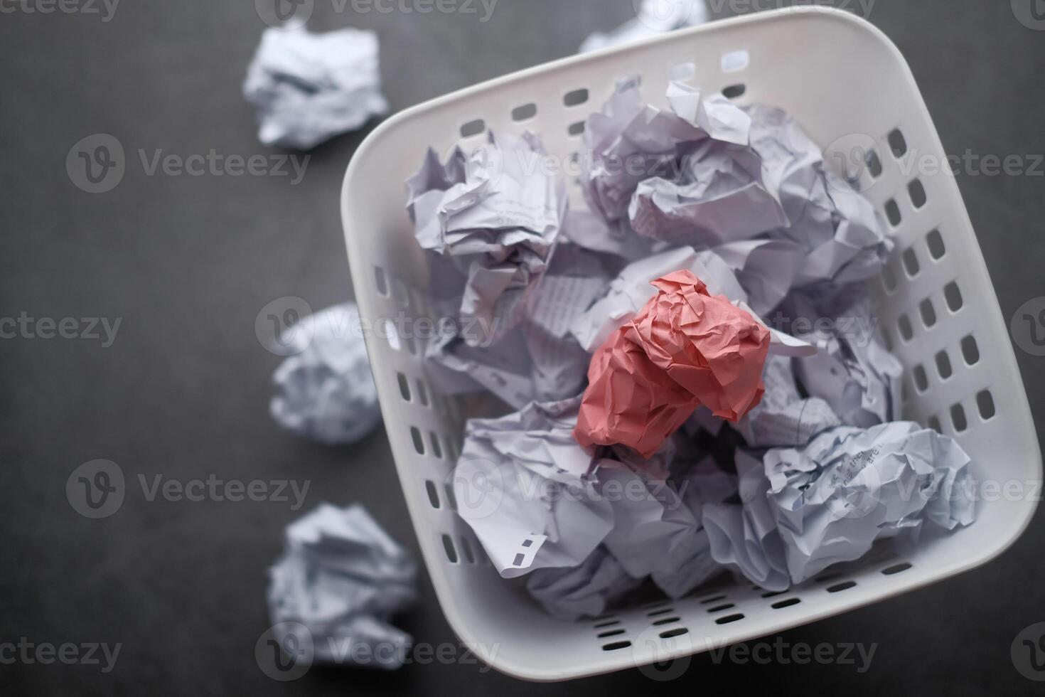 A visually appealing assortment of Colorful Crumpled Paper in a Basket on a Dark Background photo