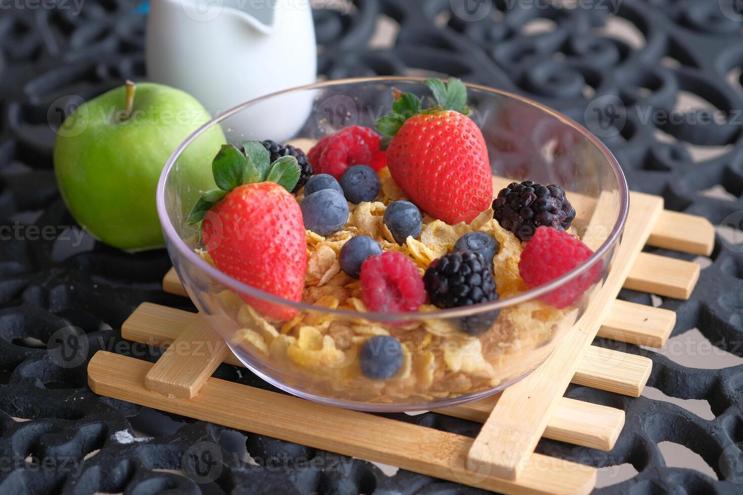 Indulge in a Delicious Cereal Bowl garnished with Fresh Berries and Crisp Green Apple slices photo