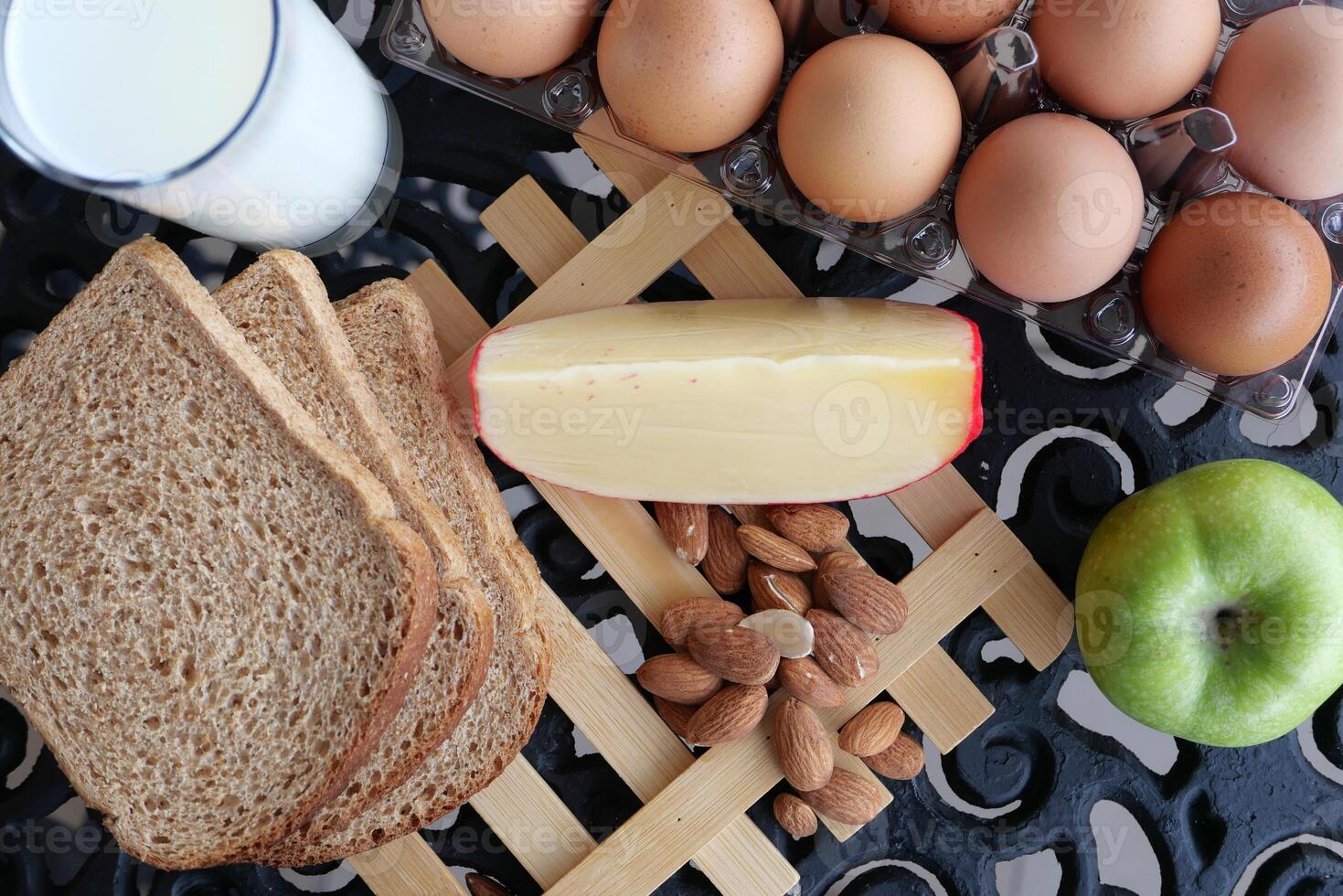 Key ingredients for a healthy breakfast are eggs, milk, bread, and various fruits photo