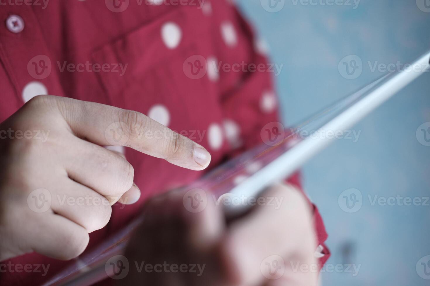 CloseUp View of Hands Actively Interacting with a Tablet Device, Engaging with Content photo