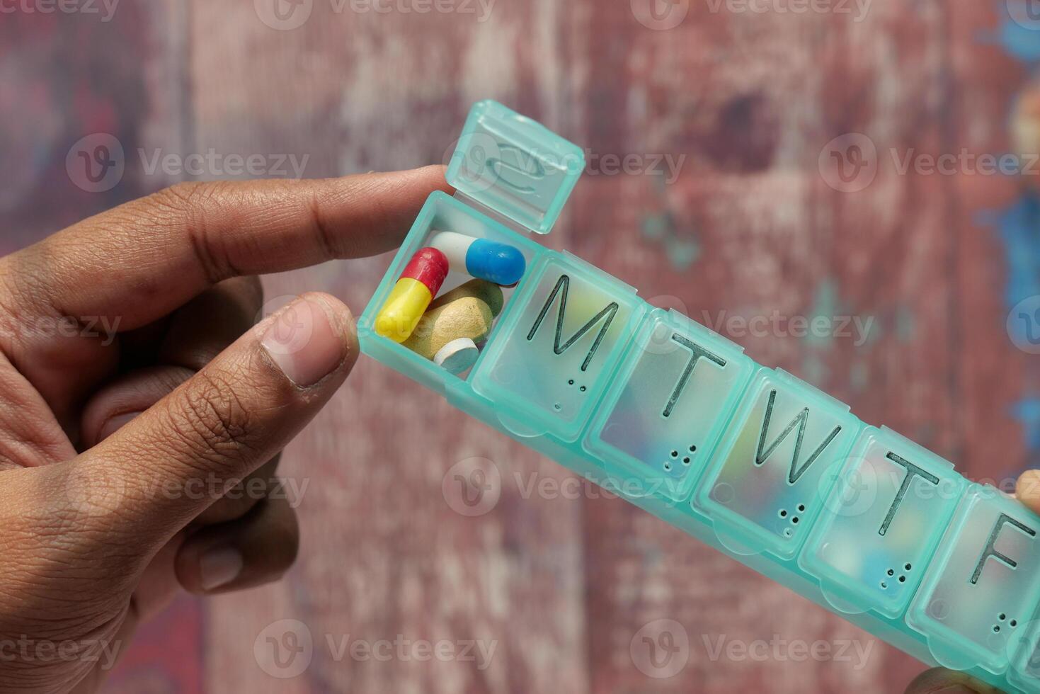 Introducing a Weekly Pill Organizer with colorful capsules for easy access and organization photo