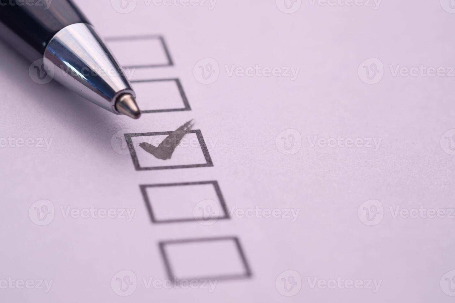 A comprehensive checklist featuring a checked box and a pen for enhancing productivity levels photo