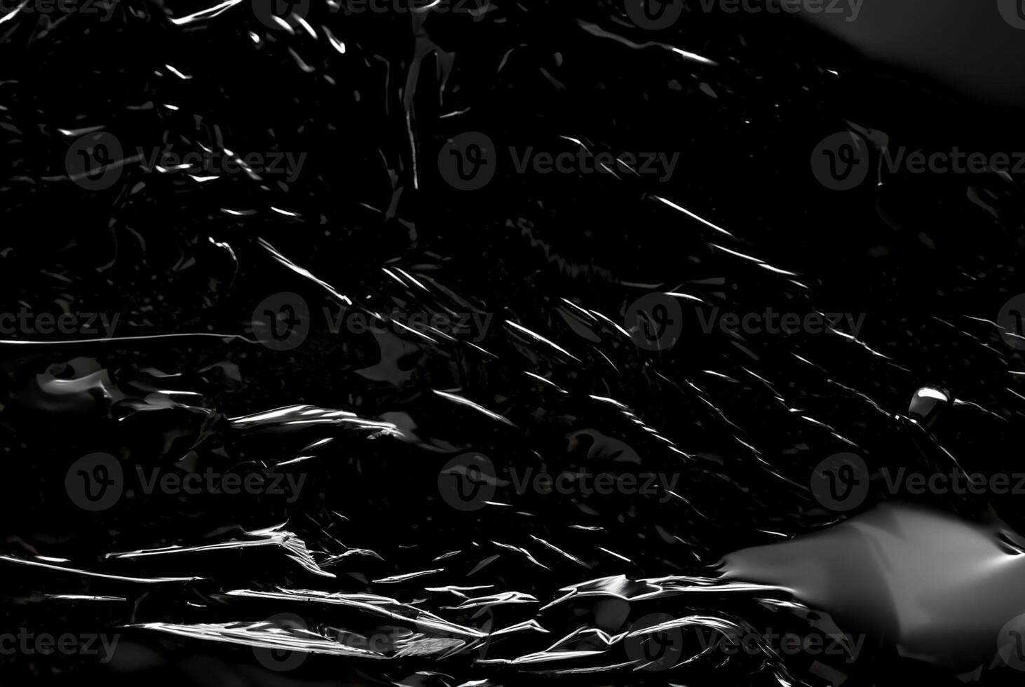 Dark abstract texture with glossy, reflective surfaces creating sharp highlights and flowing lines. photo